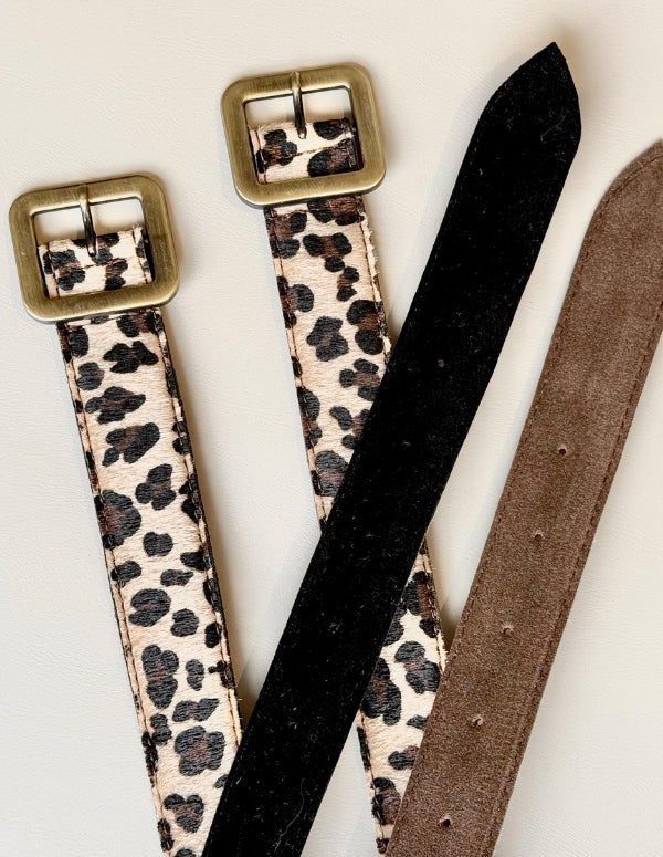Detalle de la textura y hebilla del cinturón estampado leopardo, fabricado 100% sin materiales de origen animal.