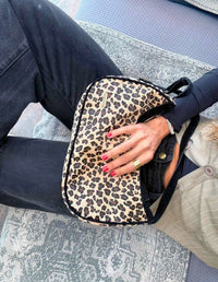 Mujer luciendo un bolso cruzado tipo hobo estampado leopardo con bordes negros. Diseño local hecho a mano en Medellín.